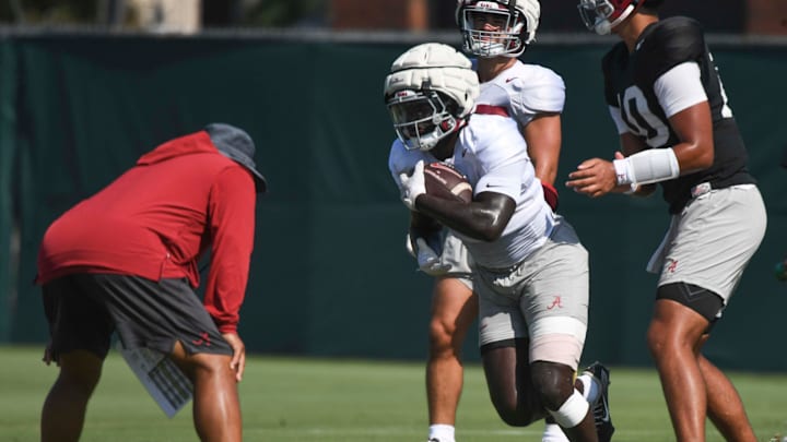 The Alabama Crimson Tide football team works out Sunday morning in practice as they prepare for the 2024 season. Alabama running back Richard Young (9) takes a handoff from Alabama quarterback Austin Mack (10).