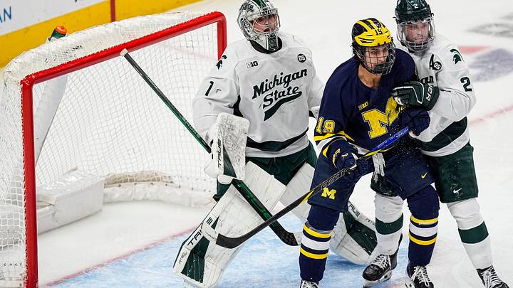 Michigan State goaltender Trey Augustine (1), left, tends net against Michigan forward Michael Hage (19) during the second period of Duel in the D at Little Caesars Arena in Detroit on Saturday, February 7, 2026.
