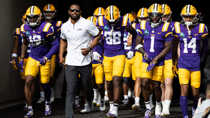 Jan 1, 2024; Tampa, FL, USA; LSU Tigers wide receivers coach Cortez Hankton, tight end Ka'Morreun Pimpton (88), and wide receiver Aaron Anderson (1) run onto the field before the game against the Wisconsin Badgers at Raymond James Stadium. Mandatory Credit: Matt Pendleton-Imagn Images