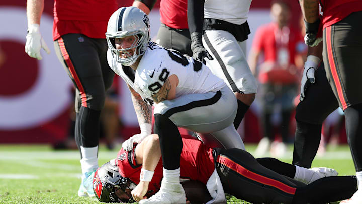 Dec 8, 2024; Tampa, Florida, USA; Las Vegas Raiders defensive end Maxx Crosby (98) sacks Tampa Bay Buccaneers quarterback Baker Mayfield (6) in the second quarter at Raymond James Stadium. Mandatory Credit: Nathan Ray Seebeck-Imagn Images