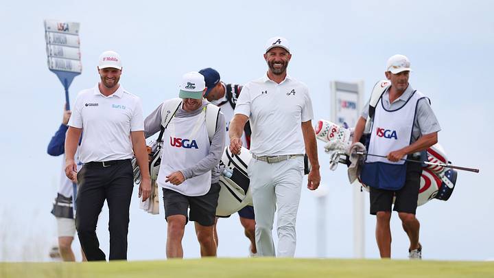 Wyndham Clark (left) walking off the first tee box with Dustin Johnson (center) during the second round of the U.S. Open. He was much more tired when the round was over. Wyndham Clark (left) walking off the first tee box with Dustin Johnson (center) during the second round of the U.S. Open. He was much more tired when the round was over.