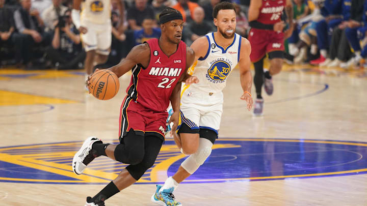 Miami Heat forward Jimmy Butler (22) dribbles past Golden State Warriors guard Stephen Curry (30) in the first quarter at the Chase Center. Mandatory Credit: Cary Edmondson-Imagn Images