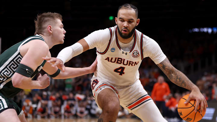 Mar 30, 2025; Atlanta, GA, USA; Auburn Tigers forward Johni Broome (4) dribbles against Michigan State Spartans forward Jaxon Kohler (0) during the first half in the South Regional final of the 2025 NCAA tournament at State Farm Arena.