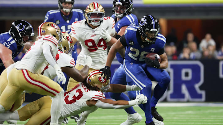 Dec 22, 2025; Indianapolis, Indiana, USA; Indianapolis Colts running back Jonathan Taylor (28) carries the ball defended by San Francisco 49ers linebacker Eric Kendricks (43) in the third quarter of the game at Lucas Oil Stadium. Mandatory Credit: Trevor Ruszkowski-Imagn Images Dec 22, 2025; Indianapolis, Indiana, USA; Indianapolis Colts running back Jonathan Taylor (28) carries the ball defended by San Francisco 49ers linebacker Eric Kendricks (43) in the third quarter of the game at Lucas Oil Stadium. Mandatory Credit: Trevor Ruszkowski-Imagn Images