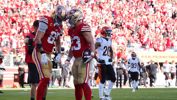 Oct 29, 2023; Santa Clara, California, USA; San Francisco 49ers tight end George Kittle (85) and running back Christian McCaffrey (23) put their helmets together after McCaffrey scored a touchdown against the Cincinnati Bengals during the fourth quarter at Levi's Stadium. Mandatory Credit: Kelley L Cox-Imagn Images