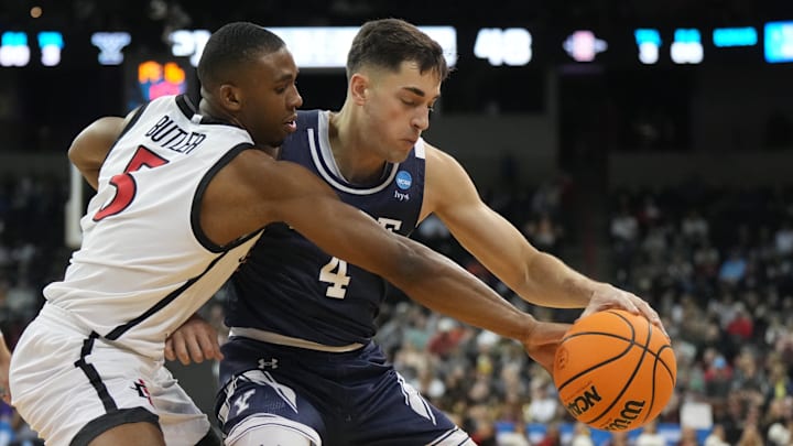 Mar 24, 2024; Spokane, WA, USA; Yale Bulldogs guard John Poulakidas (4) battles San Diego State Aztecs guard Lamont Butler (5) for the ball in the second half at Spokane Veterans Memorial Arena. Mandatory Credit: Kirby Lee-Imagn Images Mar 24, 2024; Spokane, WA, USA; Yale Bulldogs guard John Poulakidas (4) battles San Diego State Aztecs guard Lamont Butler (5) for the ball in the second half at Spokane Veterans Memorial Arena. Mandatory Credit: Kirby Lee-Imagn Images