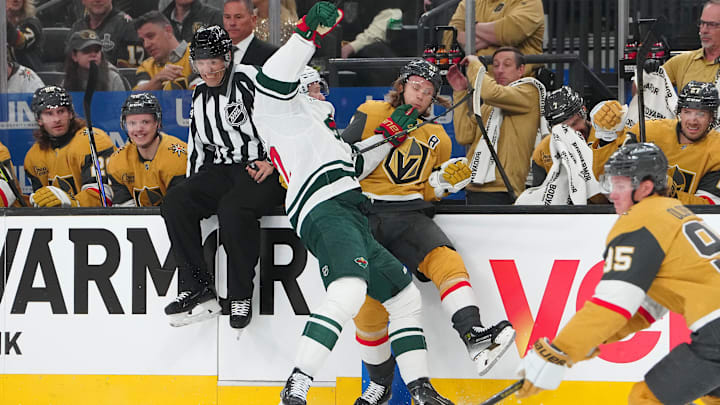 Apr 20, 2025; Las Vegas, Nevada, USA; Minnesota Wild left wing Matt Boldy (12) checks Vegas Golden Knights center William Karlsson (71) during the first period of game one of the first round of the 2025 Stanley Cup Playoffs at T-Mobile Arena. Mandatory Credit: Stephen R. Sylvanie-Imagn Images