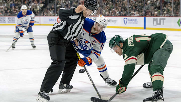Jan 15, 2025; Saint Paul, Minnesota, USA;  Minnesota Wild forward Joel Eriksson Ek (14) beats Edmonton Oilers forward Connor McDavid (97) on a face-off during the second period at Xcel Energy Center. Mandatory Credit: Nick Wosika-Imagn Images

