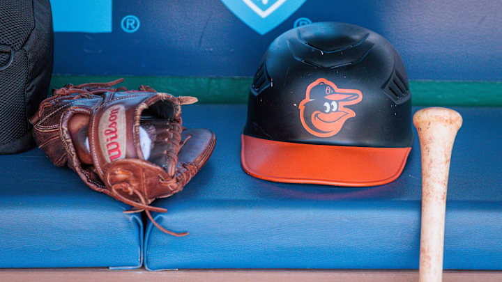 Apr 21, 2024; Kansas City, Missouri, USA; Baltimore Orioles hat and glove sits in the dugout during the ninth inning against the Kansas City Royals at Kauffman Stadium. Apr 21, 2024; Kansas City, Missouri, USA; Baltimore Orioles hat and glove sits in the dugout during the ninth inning against the Kansas City Royals at Kauffman Stadium.
