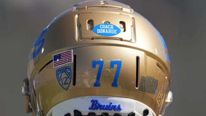 Aug 28, 2021; Pasadena, California, USA; Detailed view of Coach Donahue decal in the memory of former UCLA Bruins coach Terry Donahue on the back of the helmet of offensive lineman Beau Taylor (77) during the game against the Hawaii Rainbow Warriors at Rose Bowl. Mandatory Credit: Kirby Lee-Imagn Images Aug 28, 2021; Pasadena, California, USA; Detailed view of Coach Donahue decal in the memory of former UCLA Bruins coach Terry Donahue on the back of the helmet of offensive lineman Beau Taylor (77) during the game against the Hawaii Rainbow Warriors at Rose Bowl. Mandatory Credit: Kirby Lee-Imagn Images