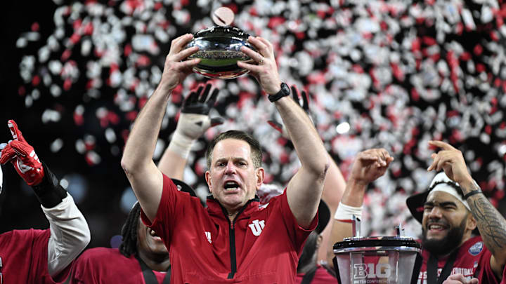 Dec 6, 2025; Indianapolis, IN, USA; Indiana Hoosiers head coach Curt Cignetti celebrates with the trophy after defeating the Ohio State Buckeyes during the 2025 Big Ten championship game at Lucas Oil Stadium. Mandatory Credit: Robert Goddin-Imagn Images Dec 6, 2025; Indianapolis, IN, USA; Indiana Hoosiers head coach Curt Cignetti celebrates with the trophy after defeating the Ohio State Buckeyes during the 2025 Big Ten championship game at Lucas Oil Stadium. Mandatory Credit: Robert Goddin-Imagn Images
