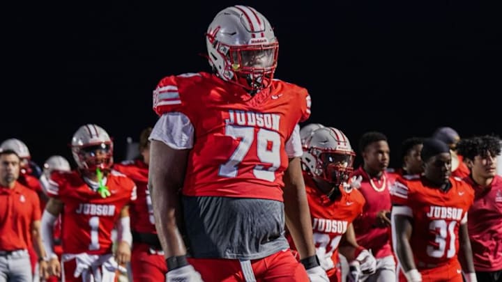 Jai’Storm Knight in his football uniform on the sidelines at Judson High School in Texas