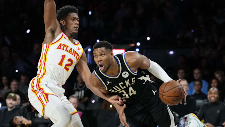 Dec 14, 2024; Las Vegas, Nevada, USA; Milwaukee Bucks forward Giannis Antetokounmpo (34) controls the ball against Atlanta Hawks forward De'Andre Hunter (12) during the third quarter in a semifinal of the 2024 Emirates NBA Cup at T-Mobile Arena. Mandatory Credit: Kyle Terada-Imagn Images