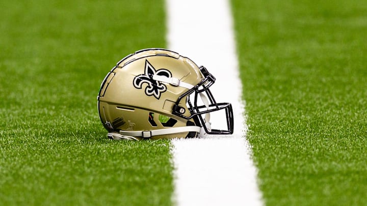 Aug 25, 2024; New Orleans, Louisiana, USA;  New Orleans Saints helmet on the turf during warmups before the game against the Tennessee Titans at Caesars Superdome. Mandatory Credit: Stephen Lew-Imagn Images