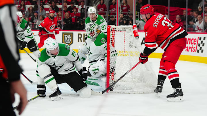 Feb 24, 2024; Raleigh, North Carolina, USA;  Carolina Hurricanes right wing Andrei Svechnikov (37) shot attempt is stopped by Dallas Stars goaltender Jake Oettinger (29) and defenseman Ryan Suter (20) during the third period at PNC Arena. Mandatory Credit: James Guillory-Imagn Images