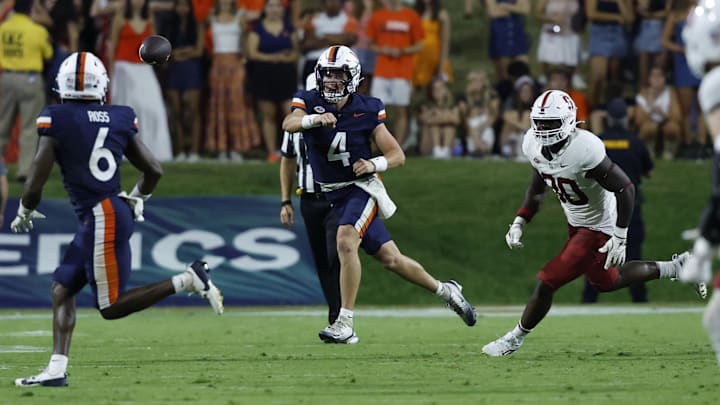 Sep 20, 2025; Charlottesville, Virginia, USA; Virginia Cavaliers quarterback Chandler Morris (4) passes the ball to Cavaliers wide receiver Cam Ross (6) as Stanford Cardinal linebacker Ese Dubre (30) chases during the second quarter at Scott Stadium. Mandatory Credit: Geoff Burke-Imagn Images Sep 20, 2025; Charlottesville, Virginia, USA; Virginia Cavaliers quarterback Chandler Morris (4) passes the ball to Cavaliers wide receiver Cam Ross (6) as Stanford Cardinal linebacker Ese Dubre (30) chases during the second quarter at Scott Stadium. Mandatory Credit: Geoff Burke-Imagn Images