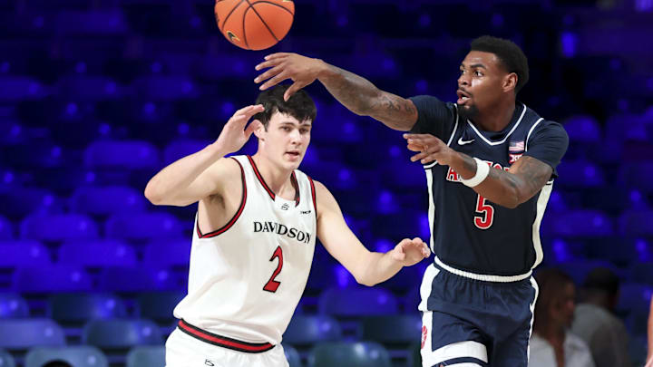 Nov 27, 2024; Paradise Island, Bahamas, BHS; Arizona Wildcats guard KJ Lewis (5) passes around Davidson Wildcats forward Bobby Durkin (2) during the first half at the Atlantis Resort.  Mandatory Credit: Kevin Jairaj-Imagn Images