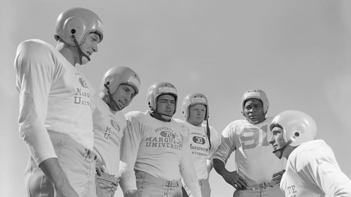 Green Bay Packers quarterback Babe Parilli talks with fellow rookies Bobby Dillon, Bill Reichardt, Chuck Boerio, Billy Howton and Tom Johnson during a training camp practice in 1952. 