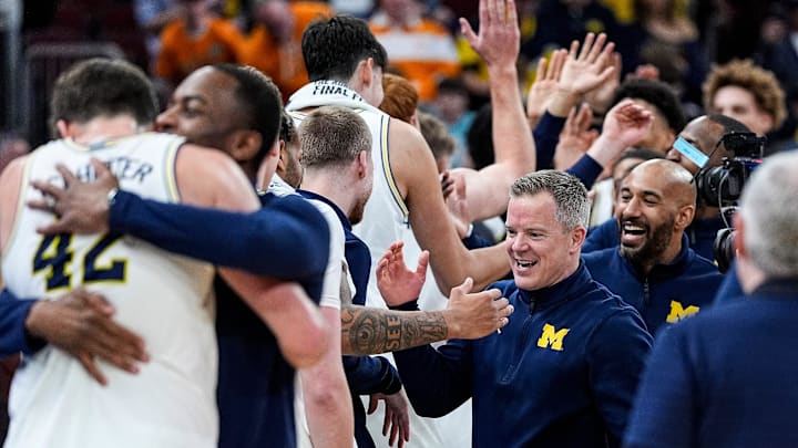 Michigan head coach Dusty May high-fives players to celebrate 95-62 win over Tennessee at the NCAA Tournament Elite 8 round at United Center in Chicago on Sunday, March 29, 2026.