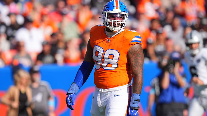 Oct 6, 2024; Denver, Colorado, USA; Denver Broncos defensive end John Franklin-Myers (98) reacts to a defensive stop in the second half against the Las Vegas Raiders at Empower Field at Mile High. Mandatory Credit: Ron Chenoy-Imagn Images
