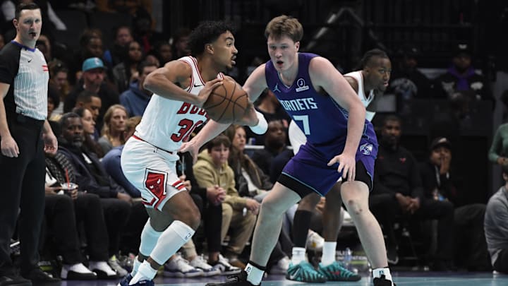 Nov 28, 2025; Charlotte, North Carolina, USA; Chicago Bulls guard Tre Jones (30) looks to pass against Charlotte Hornets guard Koa Knueppel (7) during the first half at the Spectrum Center. Mandatory Credit: Sam Sharpe-Imagn Images Nov 28, 2025; Charlotte, North Carolina, USA; Chicago Bulls guard Tre Jones (30) looks to pass against Charlotte Hornets guard Koa Knueppel (7) during the first half at the Spectrum Center. Mandatory Credit: Sam Sharpe-Imagn Images