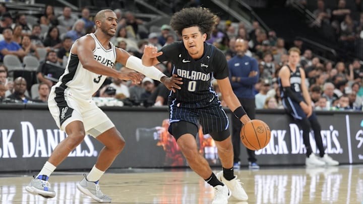 Orlando Magic guard Anthony Black (0) drives past San Antonio Spurs guard Chris Paul (3) in the second half at Frost Bank Center.