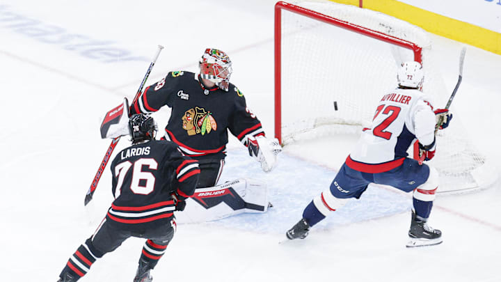Jan 9, 2026; Chicago, Illinois, USA; Washington Capitals left wing Anthony Beauvillier (72) scores against Chicago Blackhawks goaltender Drew Commesso (33) during the first period at United Center. Mandatory Credit: Kamil Krzaczynski-Imagn Images
