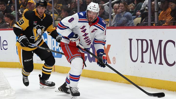 Jan 31, 2026; Pittsburgh, Pennsylvania, USA;  New York Rangers center J.T. Miller (8) moves the puck against Pittsburgh Penguins right wing Egor Chinakhov (59) during the second period at PPG Paints Arena. Mandatory Credit: Charles LeClaire-Imagn Images