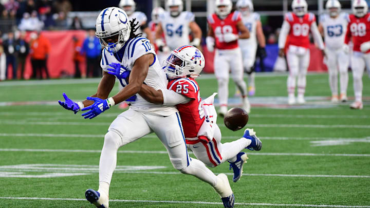 Dec 1, 2024; Foxborough, Massachusetts, USA;  Indianapolis Colts wide receiver Adonai Mitchell (10) drops a pass while New England Patriots cornerback Marcus Jones (25) defends during the second half at Gillette Stadium. Mandatory Credit: Bob DeChiara-Imagn Images