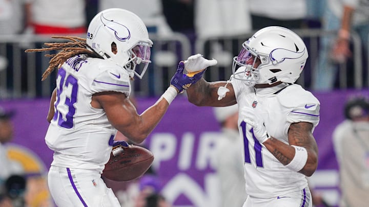 Dec 16, 2024; Minneapolis, Minnesota, USA; Minnesota Vikings running back Aaron Jones (33) celebrates his touchdown with wide receiver Trent Sherfield Sr. (11) against the Chicago Bears in the third quarter at U.S. Bank Stadium.