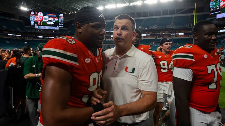 Sep 13, 2025; Miami Gardens, Florida, USA; Miami Hurricanes head coach Mario Cristobal celebrates with defensive lineman Ahmad Moten Sr. (99) after the game against the South Florida Bulls at Hard Rock Stadium. Mandatory Credit: Sam Navarro-Imagn Images