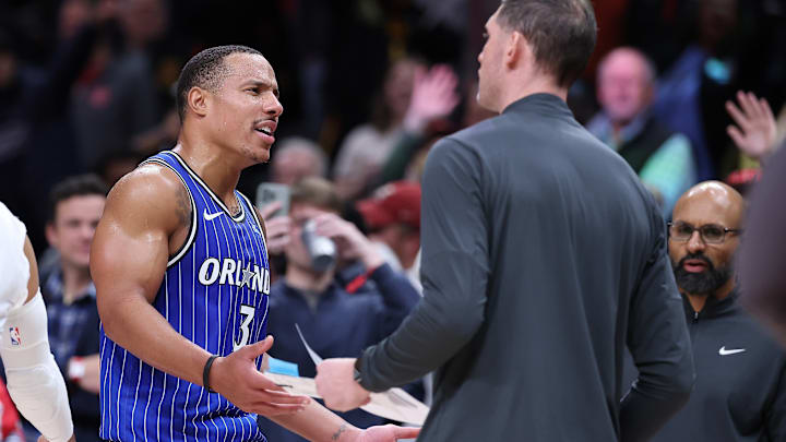 A seemingly confused Desmond Bane argues with his coaching staff after being ejected. A fan waves goodbye in the background. A seemingly confused Desmond Bane argues with his coaching staff after being ejected. A fan waves goodbye in the background.