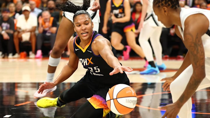 Oct 8, 2025; Phoenix, Arizona, USA; Phoenix Mercury forward Alyssa Thomas (25) dives for a loose ball against the Las Vegas Aces in the first half during game three of the 2025 WNBA Finals at PHX Arena. Mandatory Credit: Mark J. Rebilas-Imagn Images