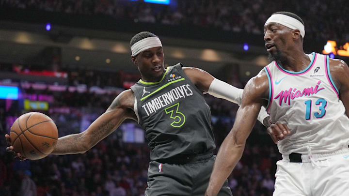 Minnesota Timberwolves forward Jaden McDaniels saves the ball from going out of play as Miami Heat center Bam Adebayo closes in during the first half at Kaseya Center in Miami on March 7, 2025. Minnesota Timberwolves forward Jaden McDaniels saves the ball from going out of play as Miami Heat center Bam Adebayo closes in during the first half at Kaseya Center in Miami on March 7, 2025.