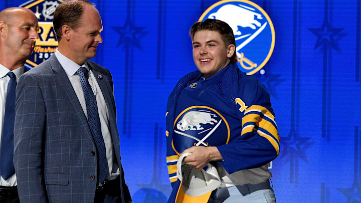 Jun 28, 2023; Nashville, Tennessee, USA; Buffalo Sabres draft pick Zach Benson puts on his sweater