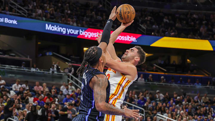 Atlanta Hawks forward Georges Niang (20) shoots against Orlando Magic forward Paolo Banchero (5) during the second quarter at Kia Center. Atlanta Hawks forward Georges Niang (20) shoots against Orlando Magic forward Paolo Banchero (5) during the second quarter at Kia Center.