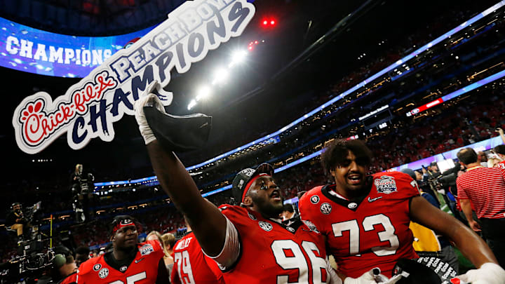 Georgia defensive lineman Zion Logue (96) and Georgia offensive lineman Xavier Truss (73) celebrate after winning the Chick-fil-A Peach Bowl NCAA College Football Playoff semifinal game between Ohio State and Georgia on Sunday, Jan 1, 2022, in Atlanta. Georgia won 42-41.

Syndication Online Athens