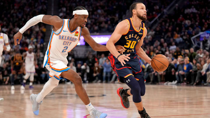 Jan 29, 2025; San Francisco, California, USA; Golden State Warriors guard Stephen Curry (30) dribbles past Oklahoma City Thunder guard Shai Gilgeous-Alexander (2) in the third quarter at the Chase Center. Mandatory Credit: Cary Edmondson-Imagn Images
