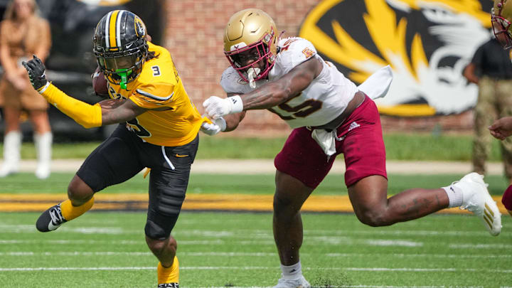 Sep 14, 2024; Columbia, Missouri, USA; Missouri Tigers wide receiver Luther Burden III (3) runs the ball as Boston College Eagles defensive end Quintayvious Hutchins (15) attempts the tackle during the second half at Faurot Field at Memorial Stadium. Mandatory Credit: Denny Medley-Imagn Images Sep 14, 2024; Columbia, Missouri, USA; Missouri Tigers wide receiver Luther Burden III (3) runs the ball as Boston College Eagles defensive end Quintayvious Hutchins (15) attempts the tackle during the second half at Faurot Field at Memorial Stadium. Mandatory Credit: Denny Medley-Imagn Images