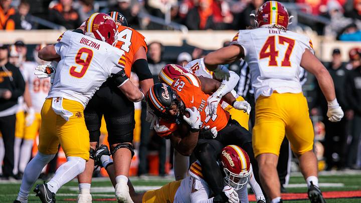 Nov 29, 2025; Stillwater, Oklahoma, USA; Oklahoma State Cowboys running back Trent Howland (24) is tackled by Iowa State Cyclones defensive back Marcus Neal (31) during the second half at Boone Pickens Stadium. Mandatory Credit: William Purnell-Imagn Images