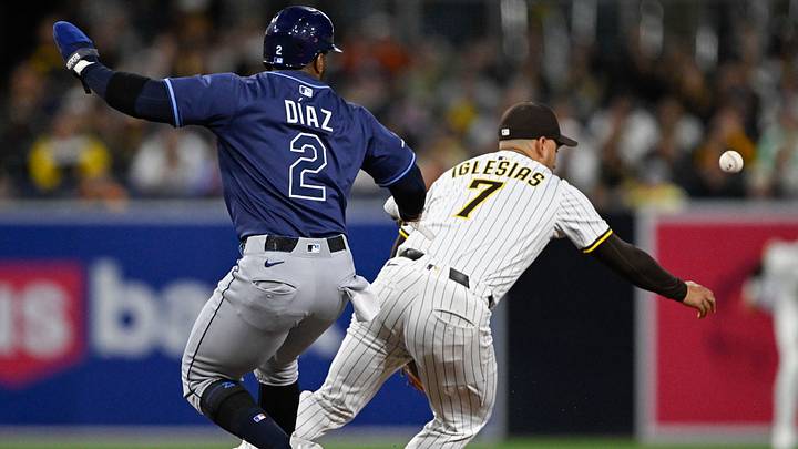 Apr 26, 2025; San Diego, California, USA; San Diego Padres second baseman Jose Iglesias (7) loses the ball as Tampa Bay Rays first baseman Yandy Diaz (2) gets onto second base during the first inning at Petco Park. Mandatory Credit: Denis Poroy-Imagn Images