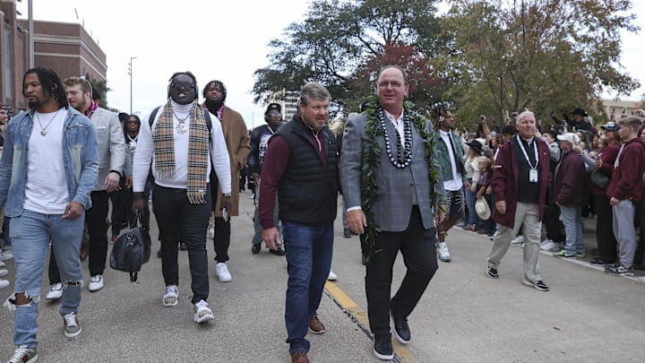 Nov 30, 2024; College Station, Texas, USA; Texas A&M Aggies head coach Mike Elko walks in with players before the game against the Texas Longhorns at Kyle Field. Mandatory Credit: Troy Taormina-Imagn Images