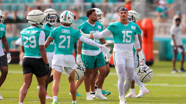 Miami Dolphins linebacker Jaelan Phillips (15) high-fives safety Ashtyn Davis (21) during training camp at Baptist Health Training Complex.
