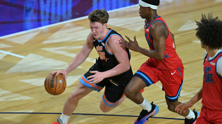 Feb 13, 2026; Inglewood, California, USA; Team T-Mac guard Kon Knueppel (7) of the Charlotte Hornets controls the ball against Team Vince guard VJ Edgecombe (77) of the Philadelphia 76ers during an NBA All Star Rising Stars game at Intuit Dome. Mandatory Credit: Jayne Kamin-Oncea-Imagn Images