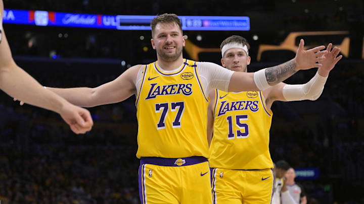 Feb 10, 2025; Los Angeles, California, USA; Los Angeles Lakers guard Luka Doncic (77) and guard Austin Reaves (15) react after a basket against the Utah Jazz at Crypto.com Arena. Mandatory Credit: Jayne Kamin-Oncea-Imagn Images