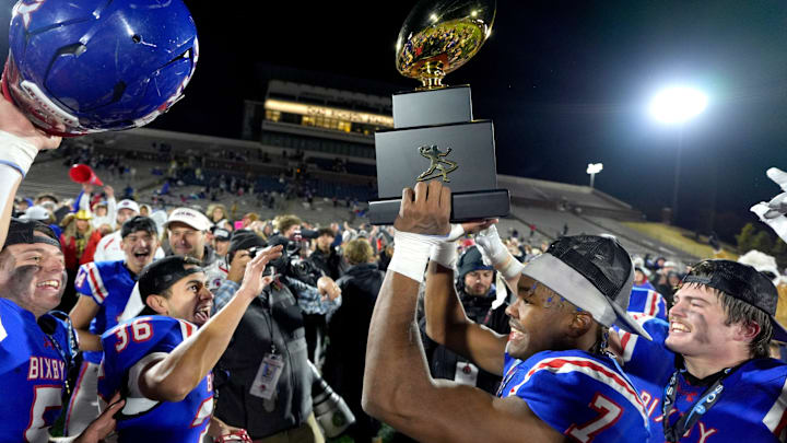 Bixby's Braeden Presley celebrates with the trophy after the Class 6A-I state football championship game between Owasso and Bixby at Chad Richison Stadium in Edmond, Okla., Friday, Dec. 6, 2024.