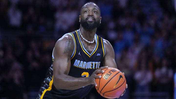 Feb 25, 2025; Milwaukee, Wisconsin, USA;  Former Marquette Golden Eagles player Dwyane Wade shoots during a timeout during the first half of the game against the Providence Friars at Fiserv Forum. Mandatory Credit: Jeff Hanisch-Imagn Images