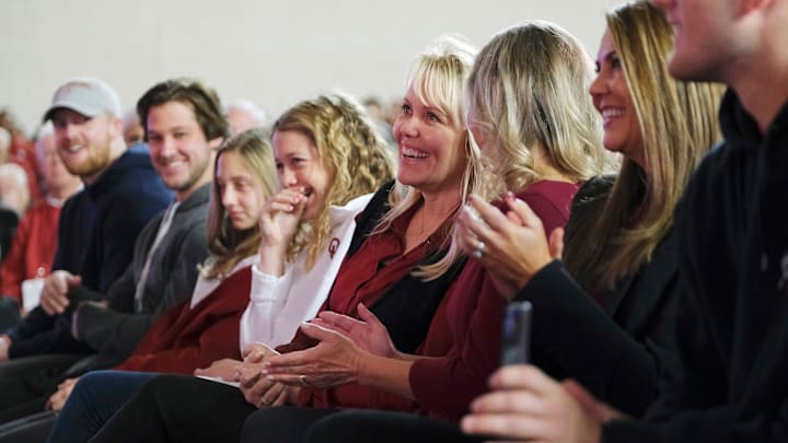 Julie Venables (center) and family laugh at a remark from her husband, new OU football coach Brent Venables, on Monday in the Everest Training Center in Norman.