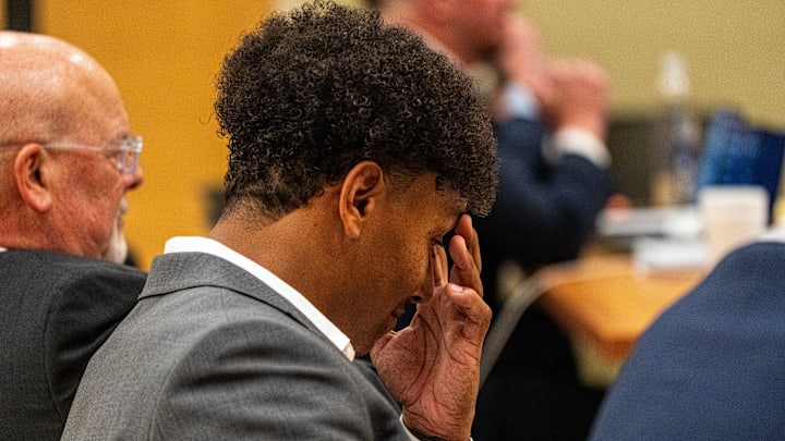 Ole Miss quarterback Trinidad Chambliss rubs his face during the hearing in his lawsuit against the NCAA at Calhoun County Courthouse in Pittsboro, Miss., on Thursday, Feb. 12, 2026. Chambliss is looking for a temporary injunction and a permanent injunction against the NCAA for one more year of eligibility.