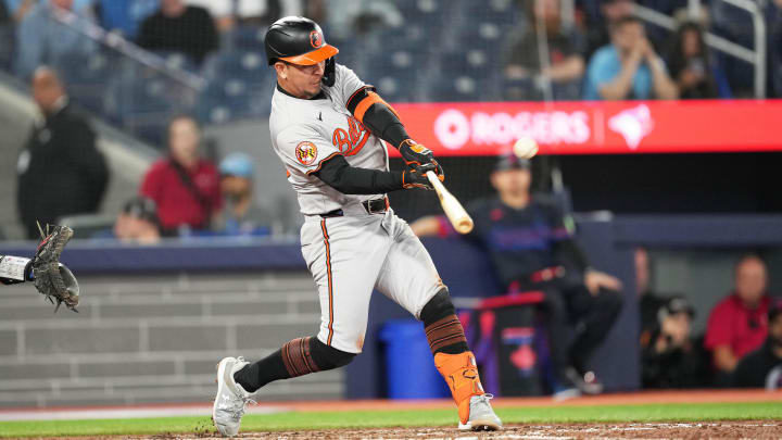 Jun 3, 2024; Toronto, Ontario, CAN; Baltimore Orioles third baseman Ramon Urias (29) hits a home run against the Toronto Blue Jays during the ninth inning at Rogers Centre. 
